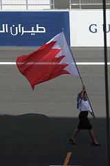 A Gulf Air stewardess carrying the Bahrain Flag on the BIC race-track during an F1 event