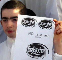 A Bahraini boy holds a banner saying 