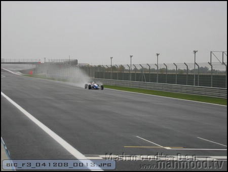 F3 car roaring past on the main straight at the Bahrain International Circuit [BIC] on December 8th, 2004 in the rain