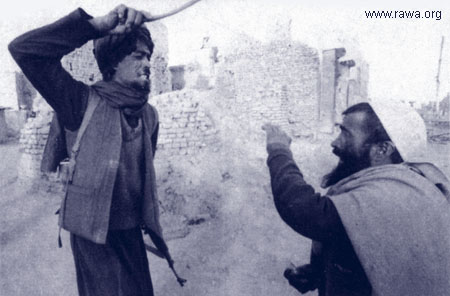 Taliban Afghani religious policeman lashing someone who is not in the mosque during prayer time.