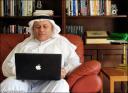 Mahmood at home using his laptop